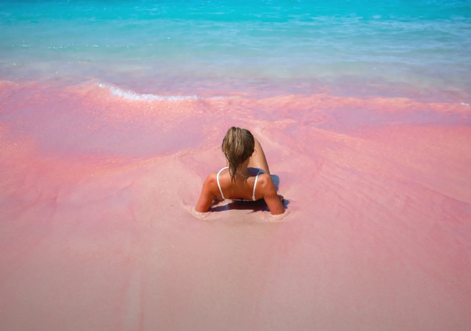 Couple lying on the pink sand at Pink Beach, Komodo National Park