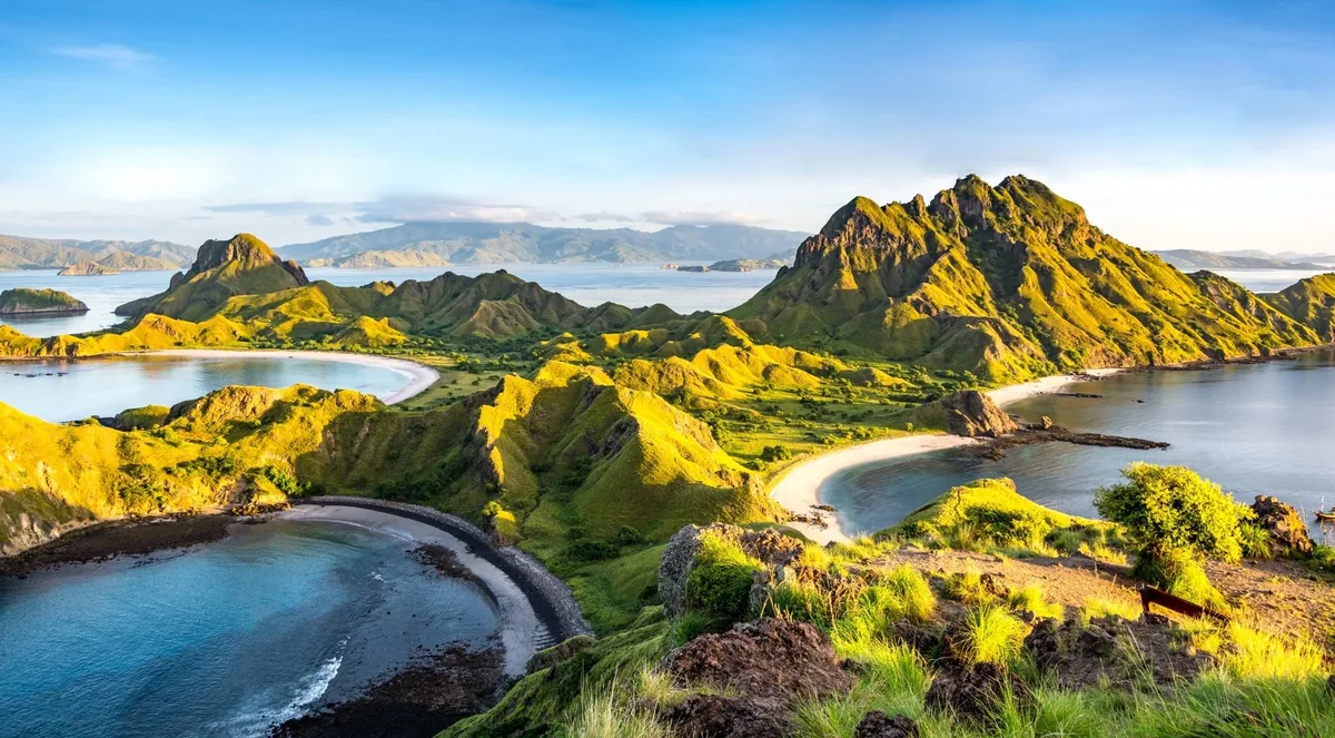 Padar Island's three bays seen from the ridge trail at golden hour